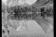 Zugspitze und Fernsteinsee umgeben von Bergen und Wald, Spiegelung im Wasser