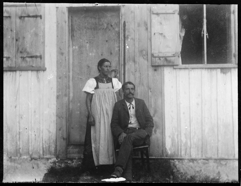 Portrait of a couple in front of house